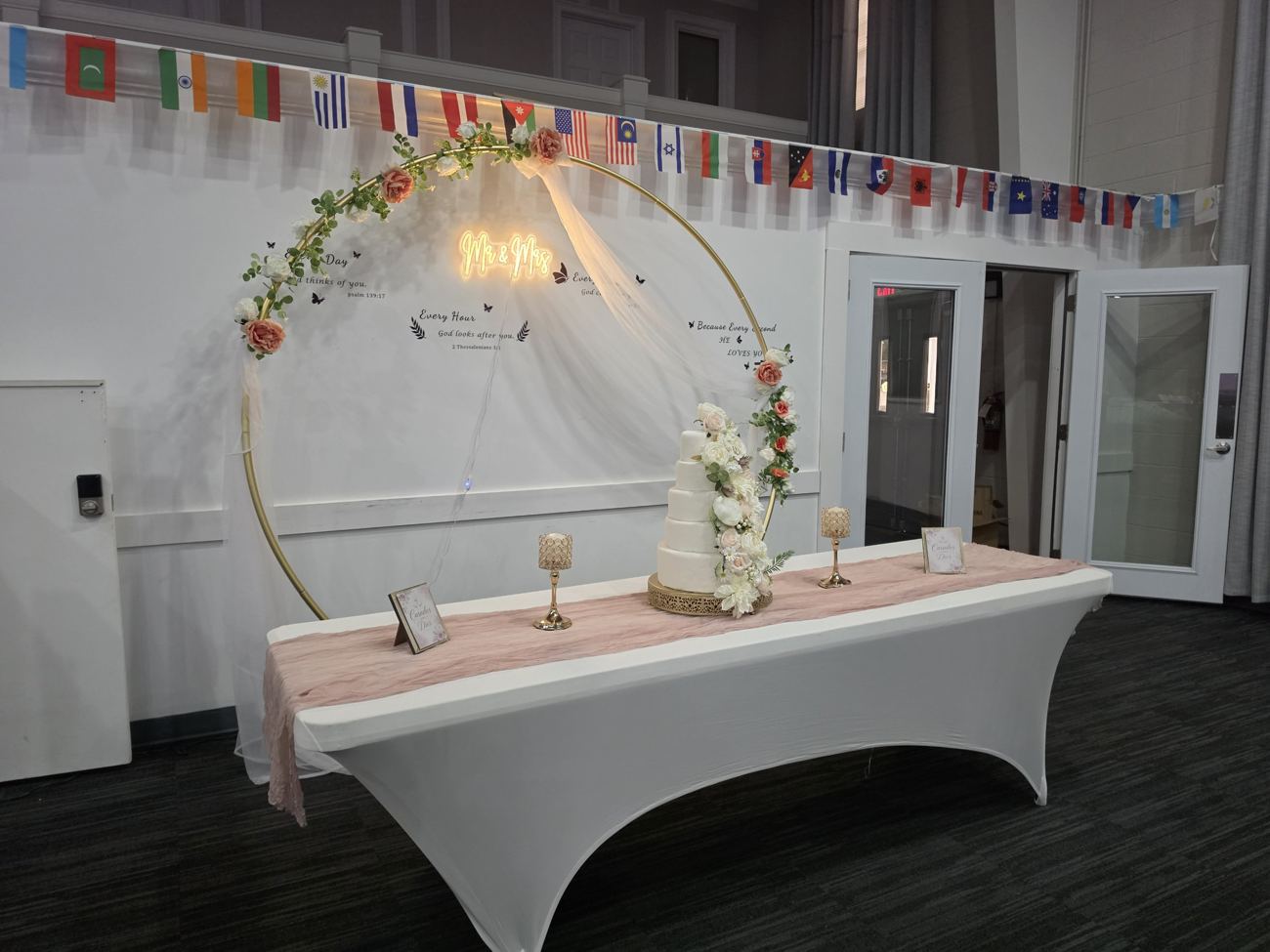 Gold ring arch with a Mr and Mrs sign and a cake