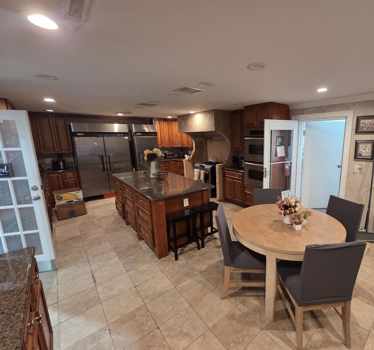 Full kitchen with a granite island and two refrigerators