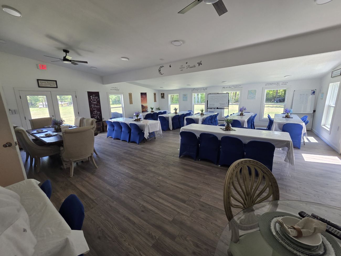 Dining hall with long tables and chairs with blue covers