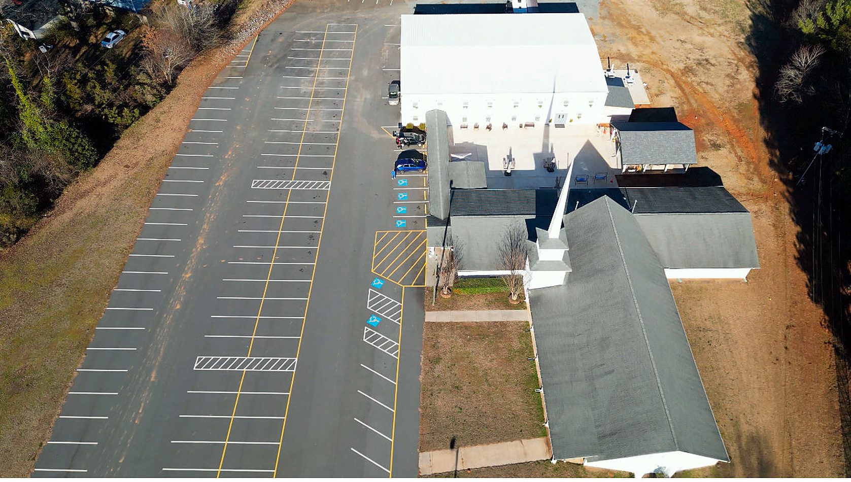 Aerial view of the parking lot, the building and the sanctuary with its steeple