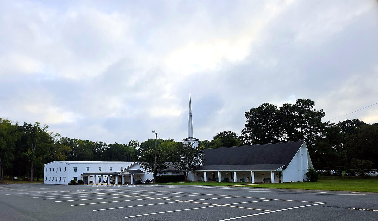 Front of the church with its steeple and the parking lot
