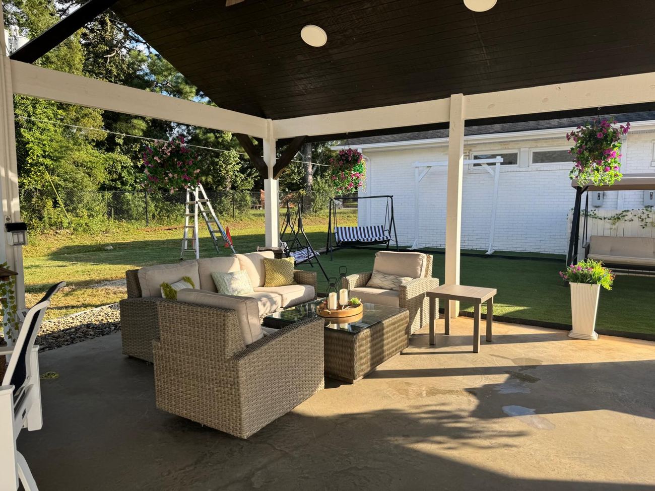 Pavilion with a wicker lounge and garden