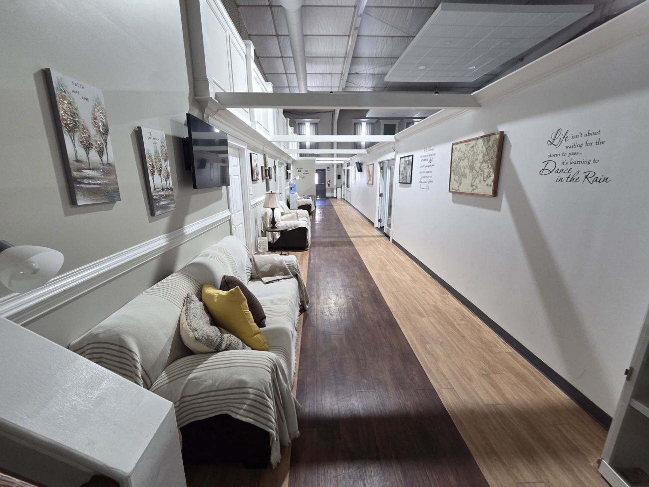 Hallway with a sitting area and screens